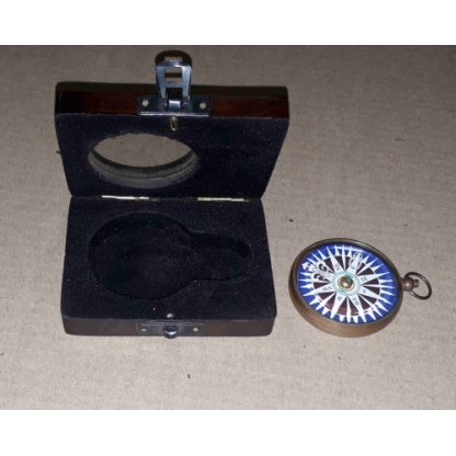 Brass compass in a solid wooden box with a floating dial.