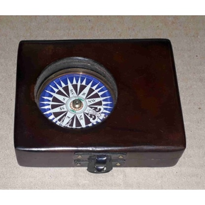 Brass compass in a solid wooden box with a floating dial.