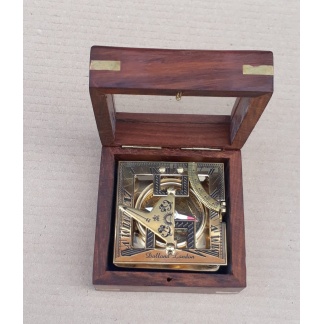 Brass sundial compass in a wooden glass box