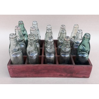 15 assorted cod bottles in a hard wood crate
