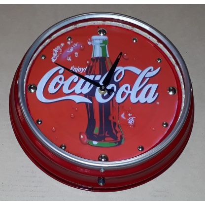 Coca-cola illuminated metal clock. 31cm diameter.